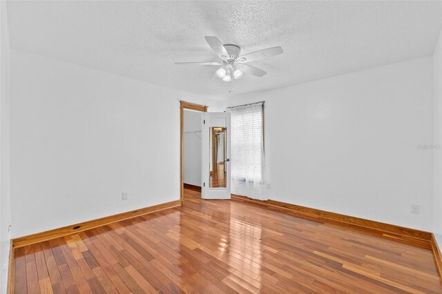 4317 Mccullough St, Port Charlotte, FL 33948 - unfurnished room featuring baseboards, a ceiling fan, hardwood / wood-style floors, and a textured ceiling