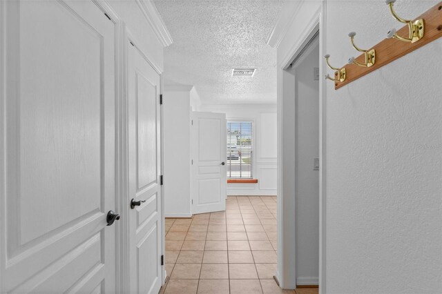 4317 Mccullough St, Port Charlotte, FL 33948 - corridor with a textured ceiling and light tile patterned flooring