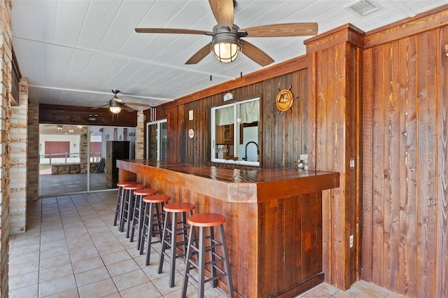 4317 Mccullough St, Port Charlotte, FL 33948 - community bar area featuring a ceiling fan, wooden walls, and light tile patterned floors