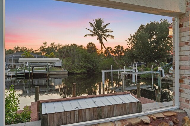 4317 Mccullough St, Port Charlotte, FL 33948 - wooden terrace with boat lift, a dock, and a water view