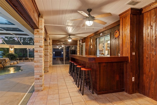 4317 Mccullough St, Port Charlotte, FL 33948 - indoor dry bar featuring wood walls, light tile patterned flooring, and ceiling fan