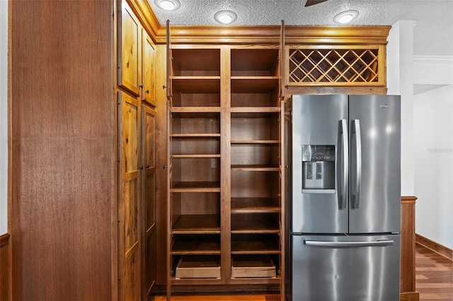 4317 Mccullough St, Port Charlotte, FL 33948 - kitchen featuring stainless steel fridge with ice dispenser, baseboards, wood finished floors, and a textured ceiling