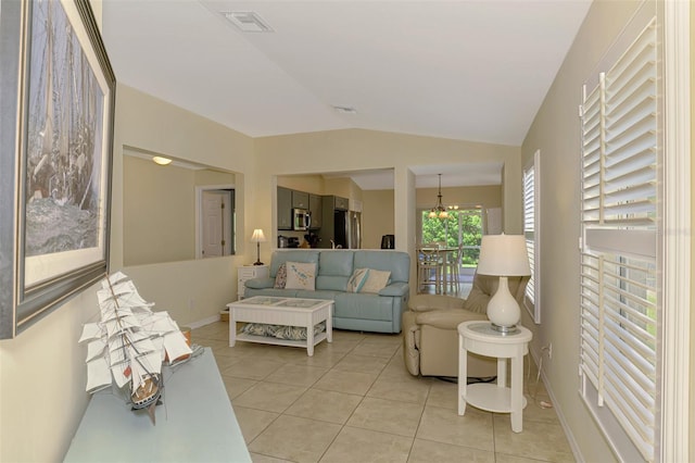 13210 SW Pembroke Cir N, Lake Suzy, FL 34269 - living area featuring lofted ceiling, light tile patterned floors, and baseboards