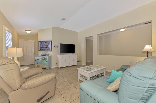 13210 SW Pembroke Cir N, Lake Suzy, FL 34269 - living area featuring lofted ceiling, light tile patterned floors, and baseboards