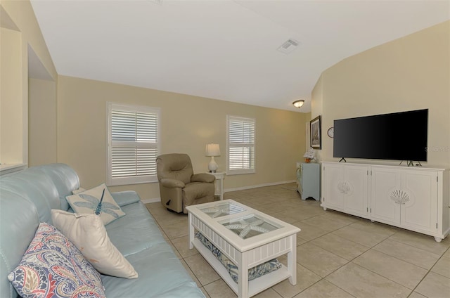 13210 SW Pembroke Cir N, Lake Suzy, FL 34269 - living area with vaulted ceiling, light tile patterned flooring, and baseboards