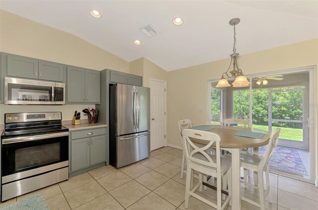 13210 SW Pembroke Cir N, Lake Suzy, FL 34269 - kitchen with appliances with stainless steel finishes, vaulted ceiling, gray cabinets, light countertops, and light tile patterned floors