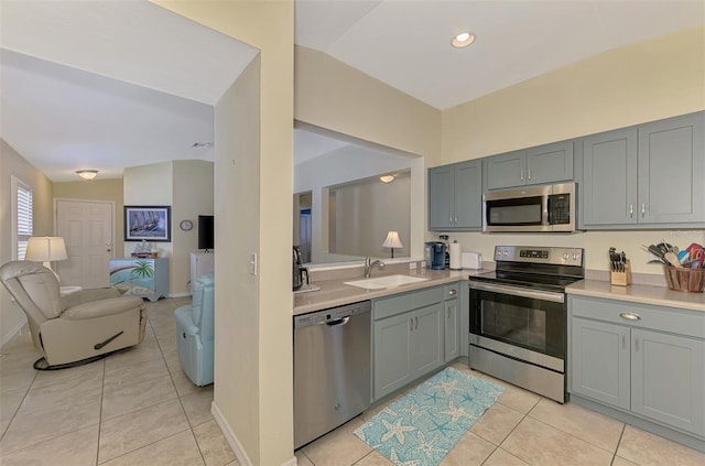 13210 SW Pembroke Cir N, Lake Suzy, FL 34269 - kitchen with appliances with stainless steel finishes, a sink, gray cabinets, light countertops, and vaulted ceiling