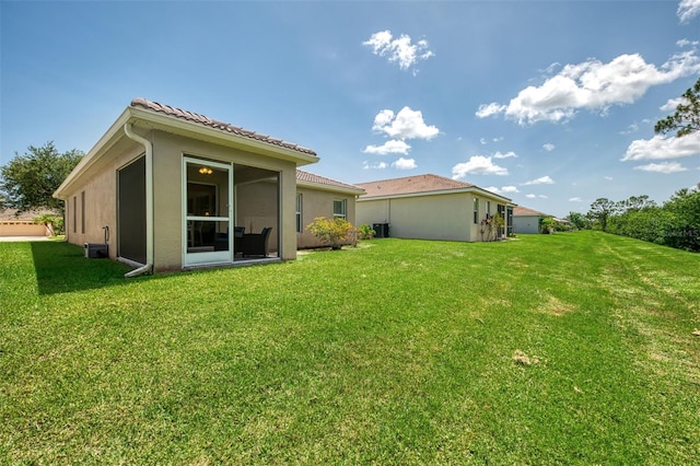 13210 SW Pembroke Cir N, Lake Suzy, FL 34269 - rear view of house with a lawn, stucco siding, and central air condition unit