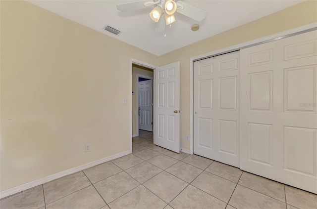 13210 SW Pembroke Cir N, Lake Suzy, FL 34269 - unfurnished bedroom featuring light tile patterned floors, baseboards, a closet, and a ceiling fan