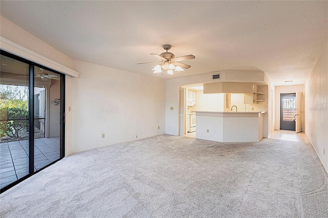 3256 White Ibis Ct Unit 24A, Punta Gorda, FL 33950 - unfurnished living room featuring light colored carpet, ceiling fan, and a sink