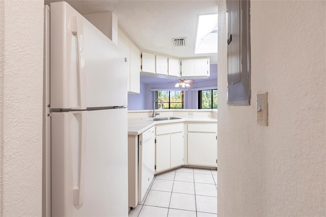 3256 White Ibis Ct Unit 24A, Punta Gorda, FL 33950 - kitchen featuring white appliances, a sink, light countertops, a textured wall, and light tile patterned floors