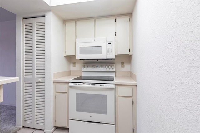 3256 White Ibis Ct Unit 24A, Punta Gorda, FL 33950 - kitchen featuring white appliances, light countertops, and a textured wall