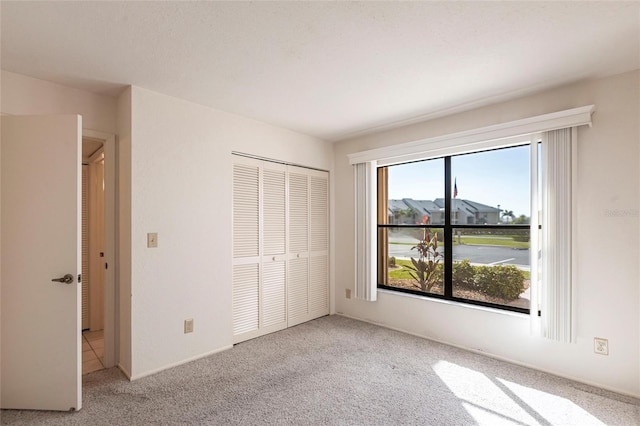 3256 White Ibis Ct Unit 24A, Punta Gorda, FL 33950 - unfurnished bedroom with carpet flooring and a closet
