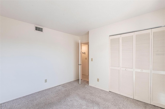 3256 White Ibis Ct Unit 24A, Punta Gorda, FL 33950 - unfurnished bedroom with light colored carpet and a closet