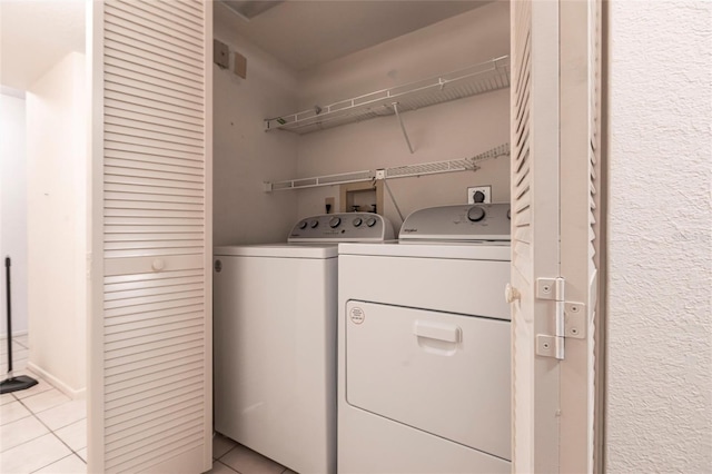 3256 White Ibis Ct Unit 24A, Punta Gorda, FL 33950 - laundry area with washing machine and clothes dryer and light tile patterned floors