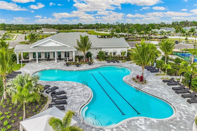 15968 Crofton Springs Way, Port Charlotte, FL 33953 - community pool featuring a patio area and view of wooded area