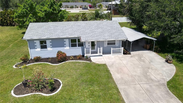 2805 Gussie St, Punta Gorda, FL 33950 - view of front of property with driveway, a shingled roof, a front lawn, a carport, and covered porch
