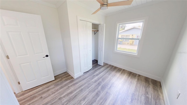 2805 Gussie St, Punta Gorda, FL 33950 - unfurnished bedroom featuring ornamental molding, light wood-style flooring, baseboards, a closet, and ceiling fan