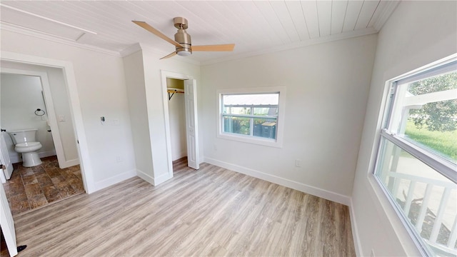 2805 Gussie St, Punta Gorda, FL 33950 - unfurnished bedroom with ornamental molding, multiple windows, a closet, baseboards, and light wood-style flooring