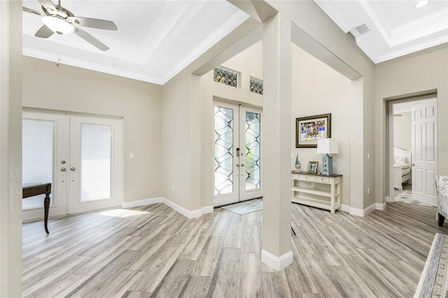 1025 Cheshire St, Port Charlotte, FL 33953 - entryway with french doors, a tray ceiling, crown molding, light wood-type flooring, and a ceiling fan