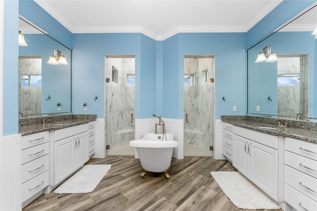 1025 Cheshire St, Port Charlotte, FL 33953 - full bathroom with a marble finish shower, wood finished floors, wainscoting, crown molding, and two vanities