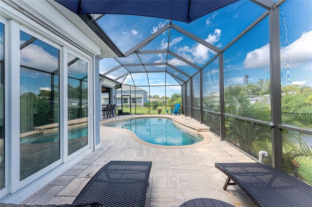 1025 Cheshire St, Port Charlotte, FL 33953 - outdoor pool featuring a patio and glass enclosure