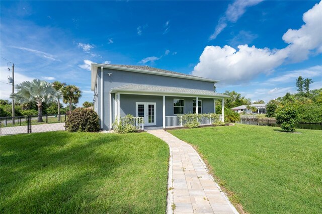 1025 Cheshire St, Port Charlotte, FL 33953 - rear view of house with stucco siding, french doors, and covered porch
