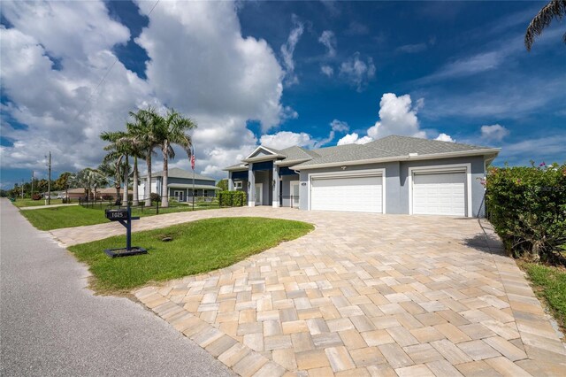 1025 Cheshire St, Port Charlotte, FL 33953 - ranch-style house featuring decorative driveway, a front yard, an attached garage, and stucco siding