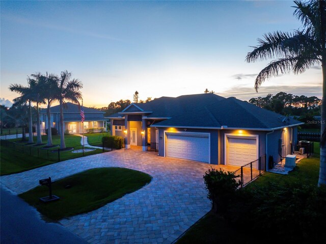 1025 Cheshire St, Port Charlotte, FL 33953 - view of front of home featuring an attached garage, decorative driveway, and stucco siding