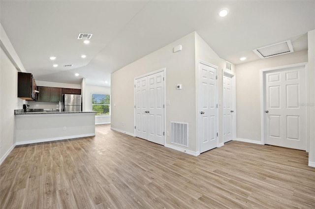 27237 Partin Dr, Punta Gorda, FL 33983 - unfurnished living room featuring light wood-style flooring, baseboards, and lofted ceiling