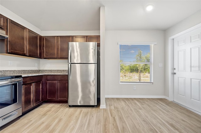 27237 Partin Dr, Punta Gorda, FL 33983 - kitchen with appliances with stainless steel finishes, light wood-style floors, baseboards, dark brown cabinets, and light stone counters