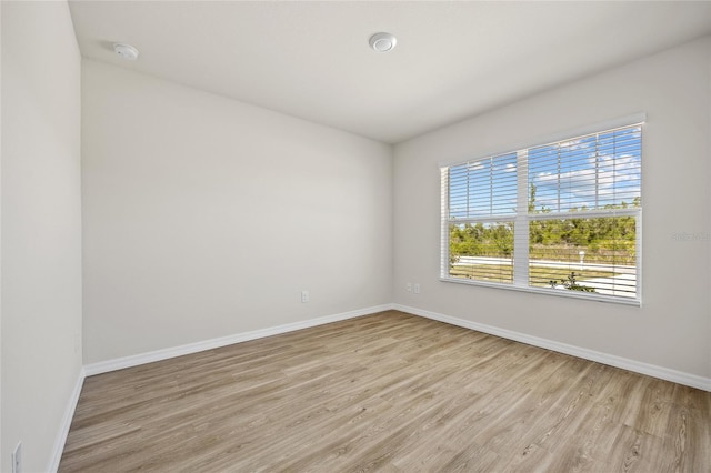 27237 Partin Dr, Punta Gorda, FL 33983 - empty room featuring light wood-style flooring, baseboards, and a smoke detector