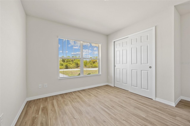 27237 Partin Dr, Punta Gorda, FL 33983 - unfurnished bedroom featuring light wood-style flooring, baseboards, and a closet