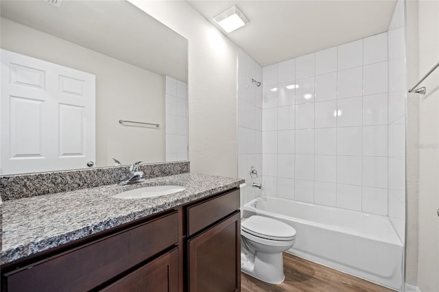 27237 Partin Dr, Punta Gorda, FL 33983 - bathroom featuring wood finished floors, toilet, vanity, and  shower combination