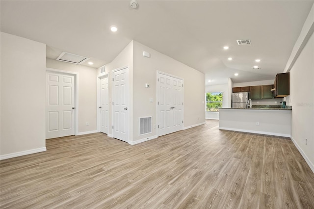 27237 Partin Dr, Punta Gorda, FL 33983 - unfurnished living room with light wood-style floors, lofted ceiling, baseboards, recessed lighting, and attic access