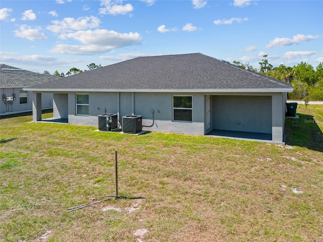 27237 Partin Dr, Punta Gorda, FL 33983 - rear view of property with central air condition unit, a lawn, and stucco siding