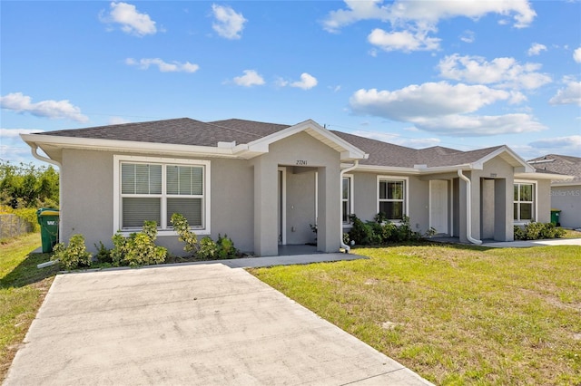27237 Partin Dr, Punta Gorda, FL 33983 - ranch-style house with a front yard and stucco siding
