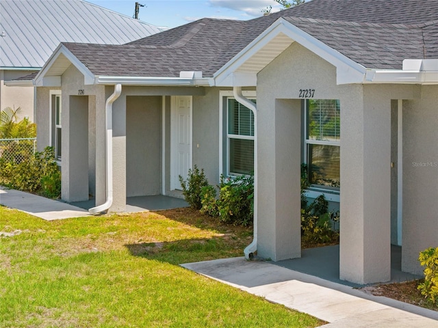 27237 Partin Dr, Punta Gorda, FL 33983 - property entrance featuring stucco siding and roof with shingles