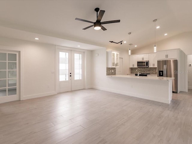17130 Elder St, Port Charlotte, FL 33954 - unfurnished living room with a ceiling fan, recessed lighting, baseboards, light wood-style flooring, and vaulted ceiling