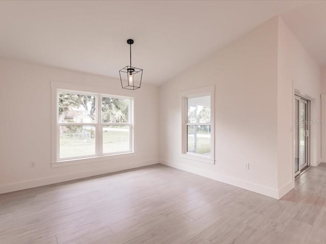 17130 Elder St, Port Charlotte, FL 33954 - spare room featuring lofted ceiling, light wood-type flooring, and baseboards