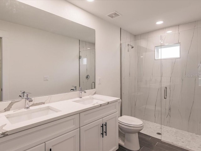 17130 Elder St, Port Charlotte, FL 33954 - bathroom with toilet, a marble finish shower, double vanity, recessed lighting, and wood finished floors