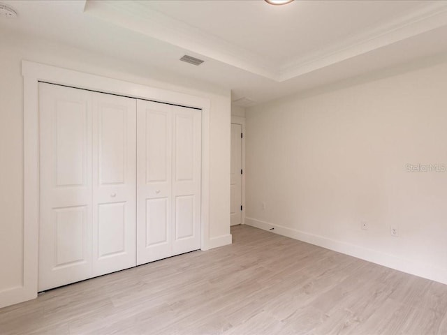 17130 Elder St, Port Charlotte, FL 33954 - unfurnished bedroom with light wood-style floors, baseboards, a closet, and crown molding