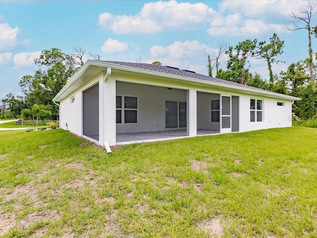 17130 Elder St, Port Charlotte, FL 33954 - back of property with a lawn, a patio, and stucco siding