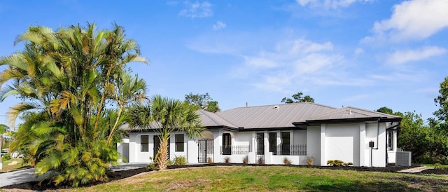 19723 Midway Blvd, Port Charlotte, FL 33948 - view of front facade featuring a front yard, stucco siding, and central air condition unit