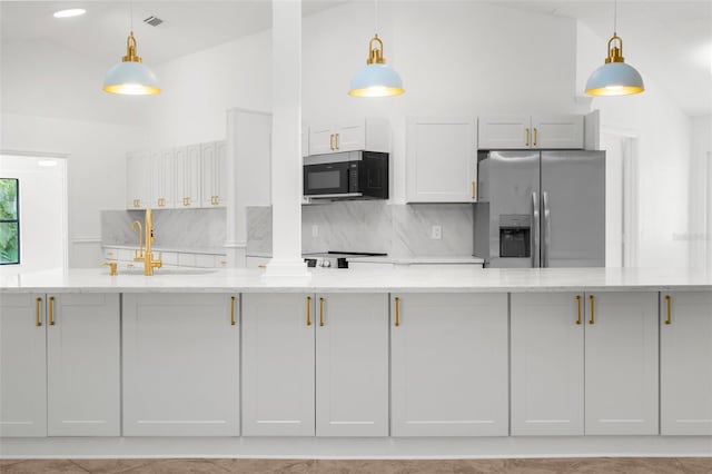 19723 Midway Blvd, Port Charlotte, FL 33948 - kitchen with stainless steel refrigerator with ice dispenser, backsplash, vaulted ceiling, a sink, and light stone counters