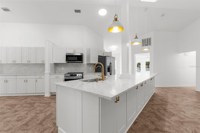 19723 Midway Blvd, Port Charlotte, FL 33948 - kitchen with stainless steel appliances, a sink, white cabinets, high vaulted ceiling, and backsplash