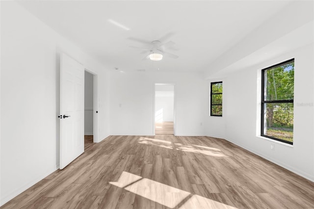 19723 Midway Blvd, Port Charlotte, FL 33948 - spare room featuring light wood-type flooring, a ceiling fan, and baseboards