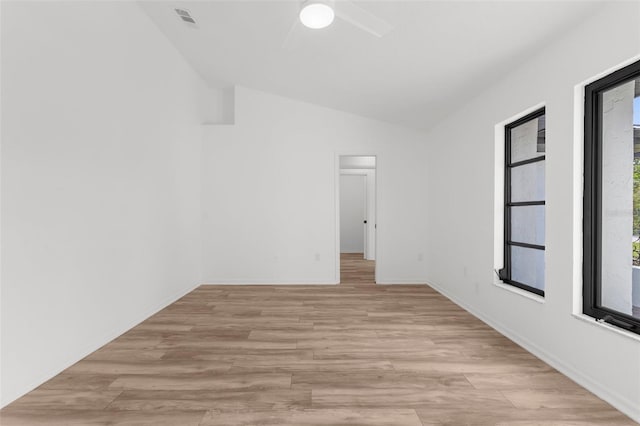 19723 Midway Blvd, Port Charlotte, FL 33948 - unfurnished room featuring vaulted ceiling, ceiling fan, light wood-style flooring, and baseboards