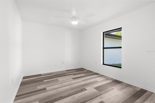 19723 Midway Blvd, Port Charlotte, FL 33948 - spare room with wood finished floors, baseboards, and a ceiling fan