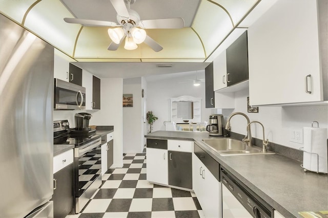3105/3109 Vasco St, Punta Gorda, FL 33950 - kitchen featuring appliances with stainless steel finishes, dark floors, ceiling fan, dark countertops, and a peninsula